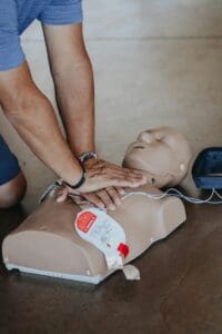 Man performing CPR on a practice dummy